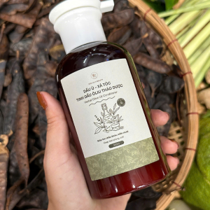 Herbal olive oil conditioner bottle surrounded by natural herbs and soap nuts